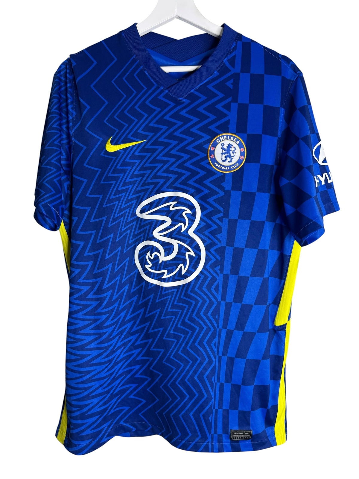 Maillot de football officiel Chelsea FC Levestiairedupeuple bleu avec motif géométrique et détails jaune vif