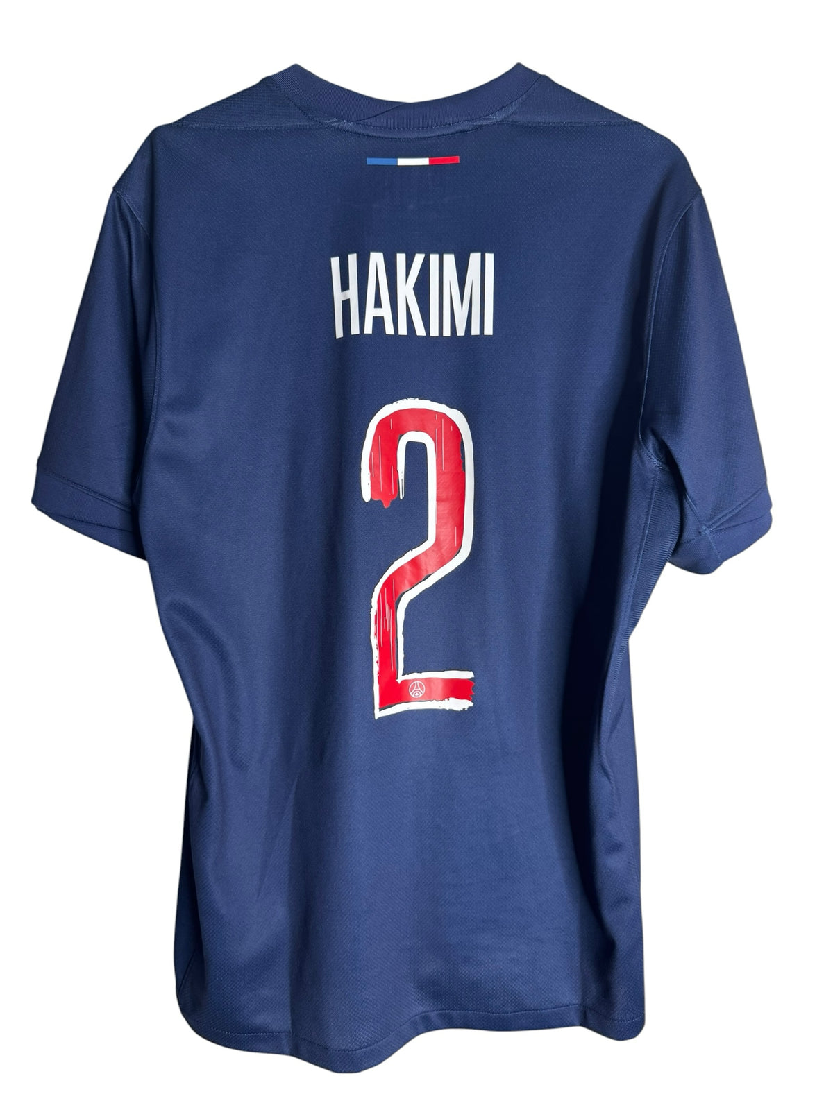 Maillot domicile officiel Levestiairedupeuple du PSG bleu avec flocage Hakimi 2 et détails tricolores au dos